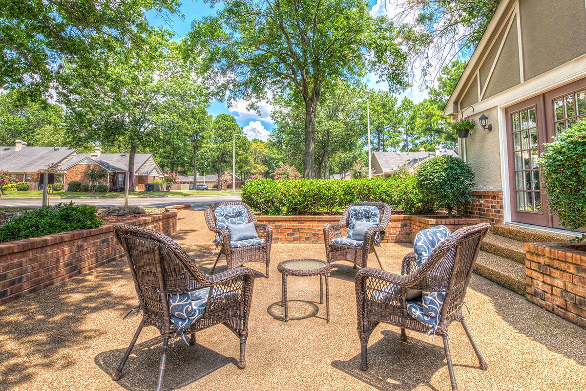 Patio area with seating and greenery.