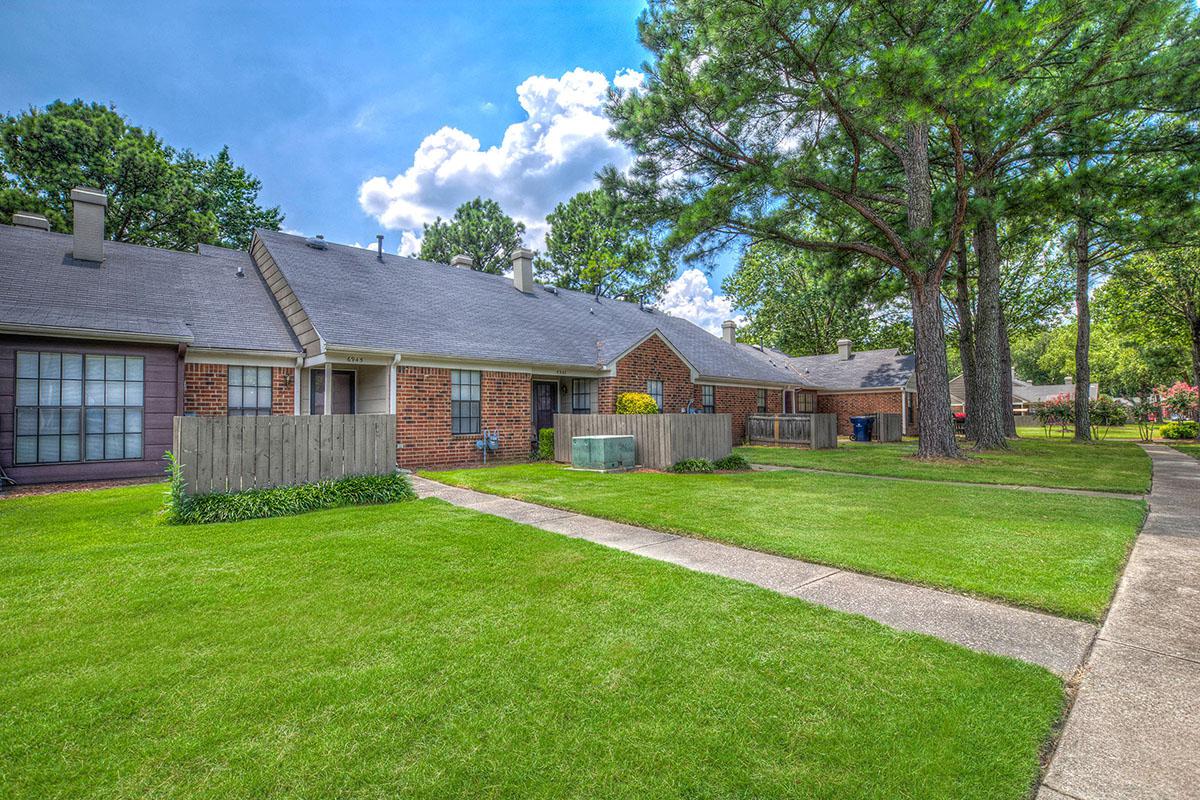 Pathway leading to brick apartment homes.