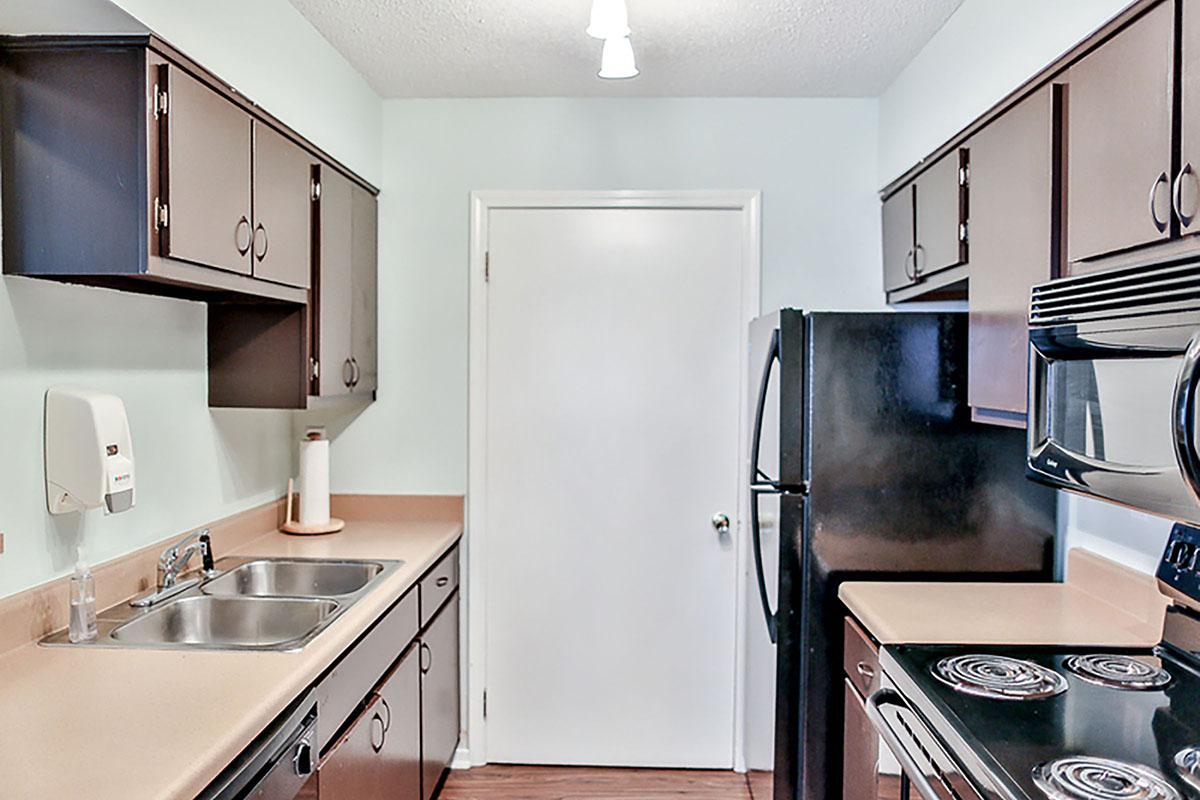 Kitchen with dark cabinets and modern appliances.