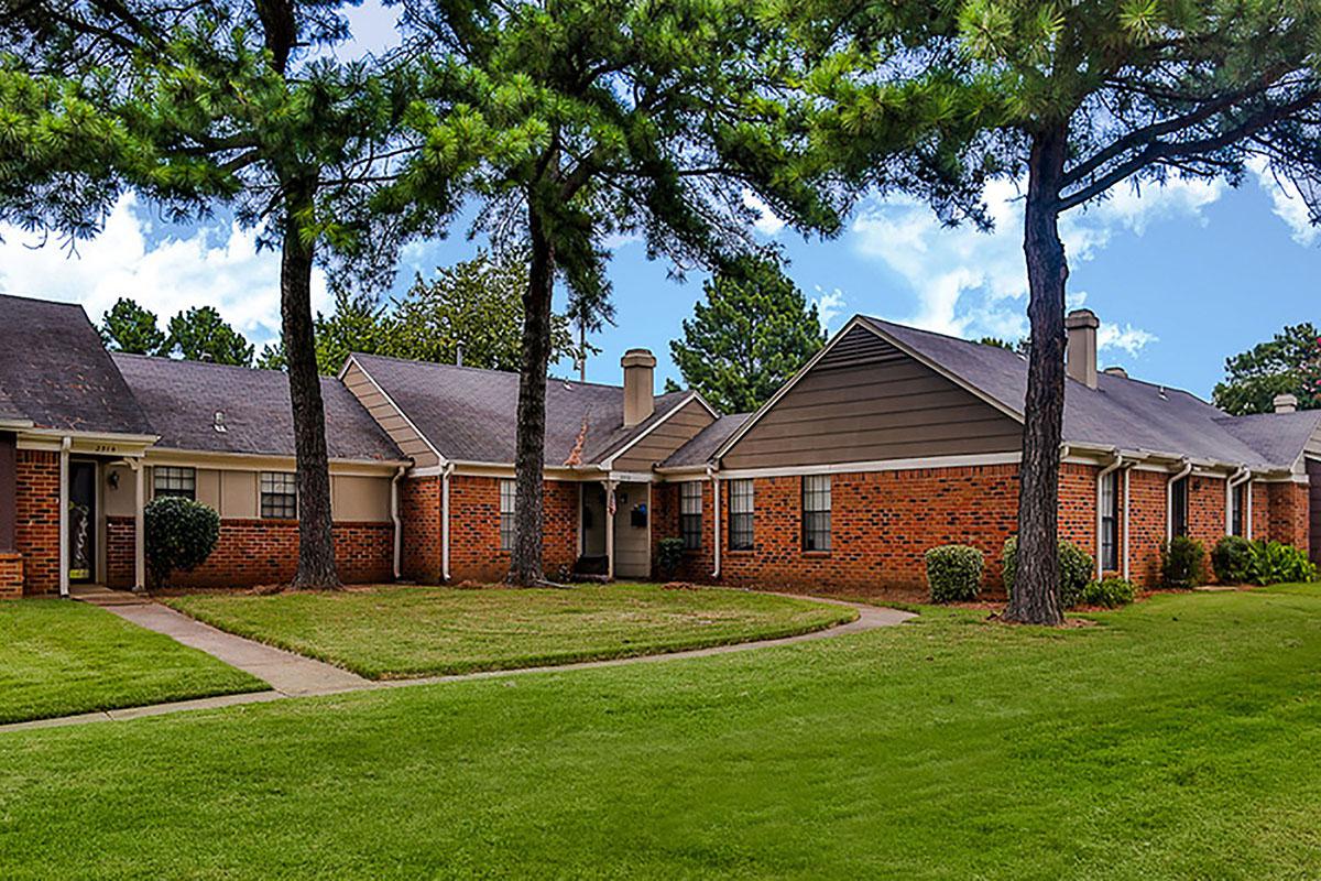 Brick apartments with manicured landscaping.