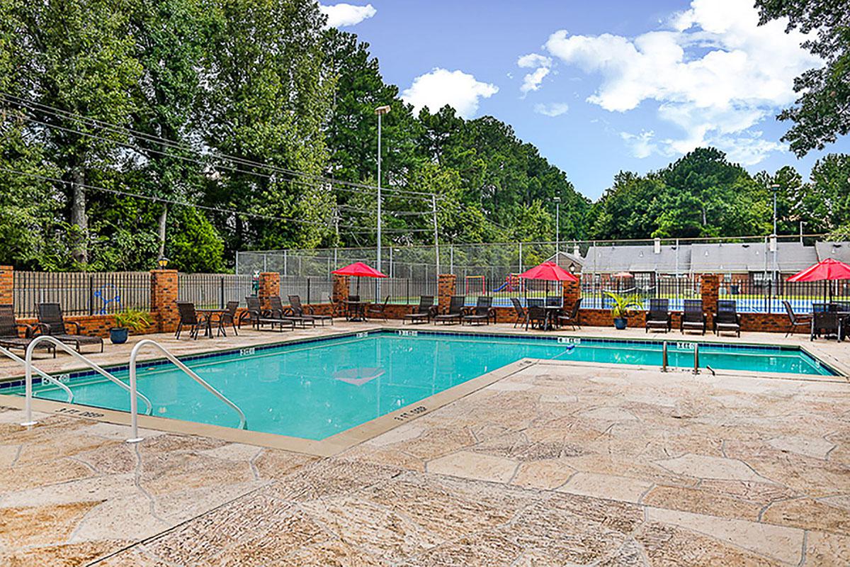 Swimming pool with umbrellas and lounge chairs.