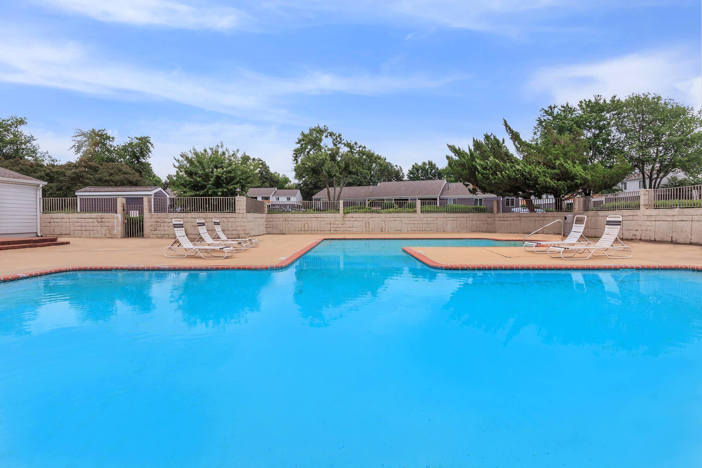 Outdoor pool with lounge chairs.