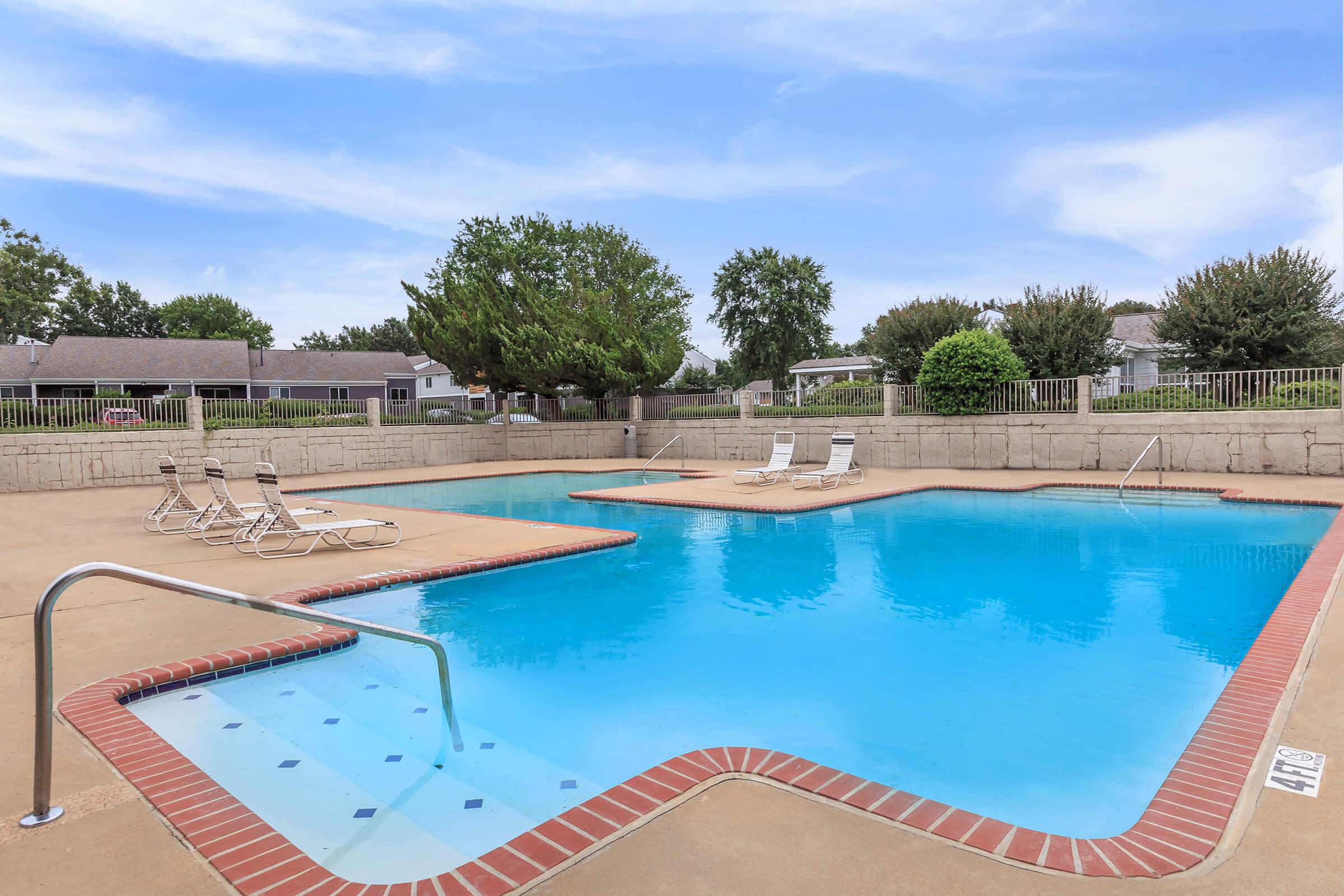 Side view of pool with landscaped lawn.