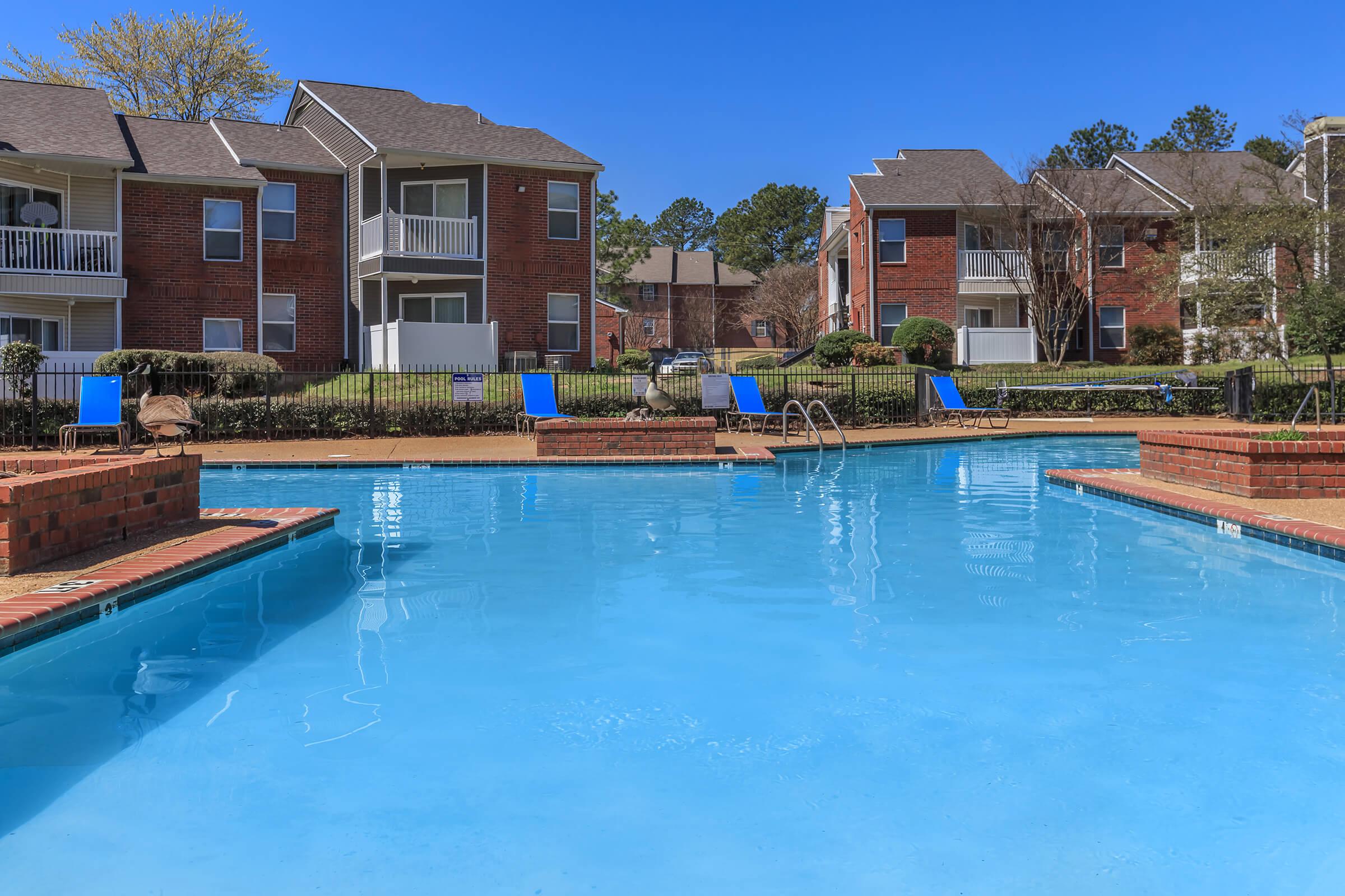 Apartment complex with outdoor pool.