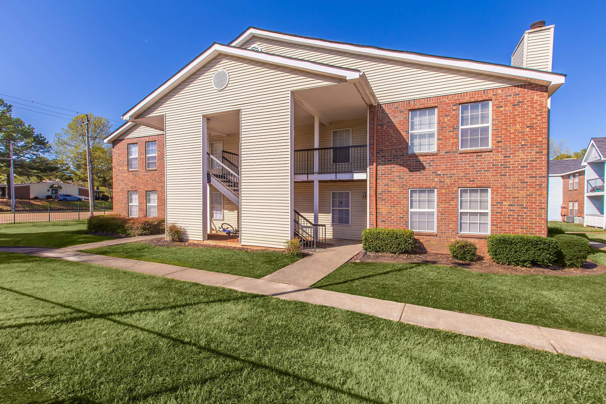 Two-story apartment building with a covered walkway.