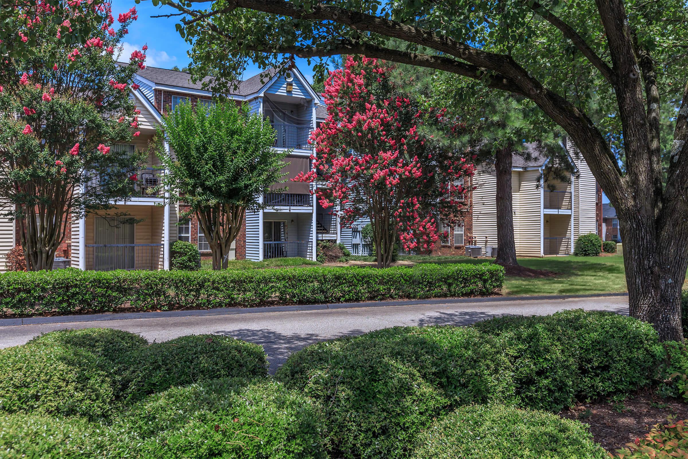 Side view of apartments with brick and white siding.