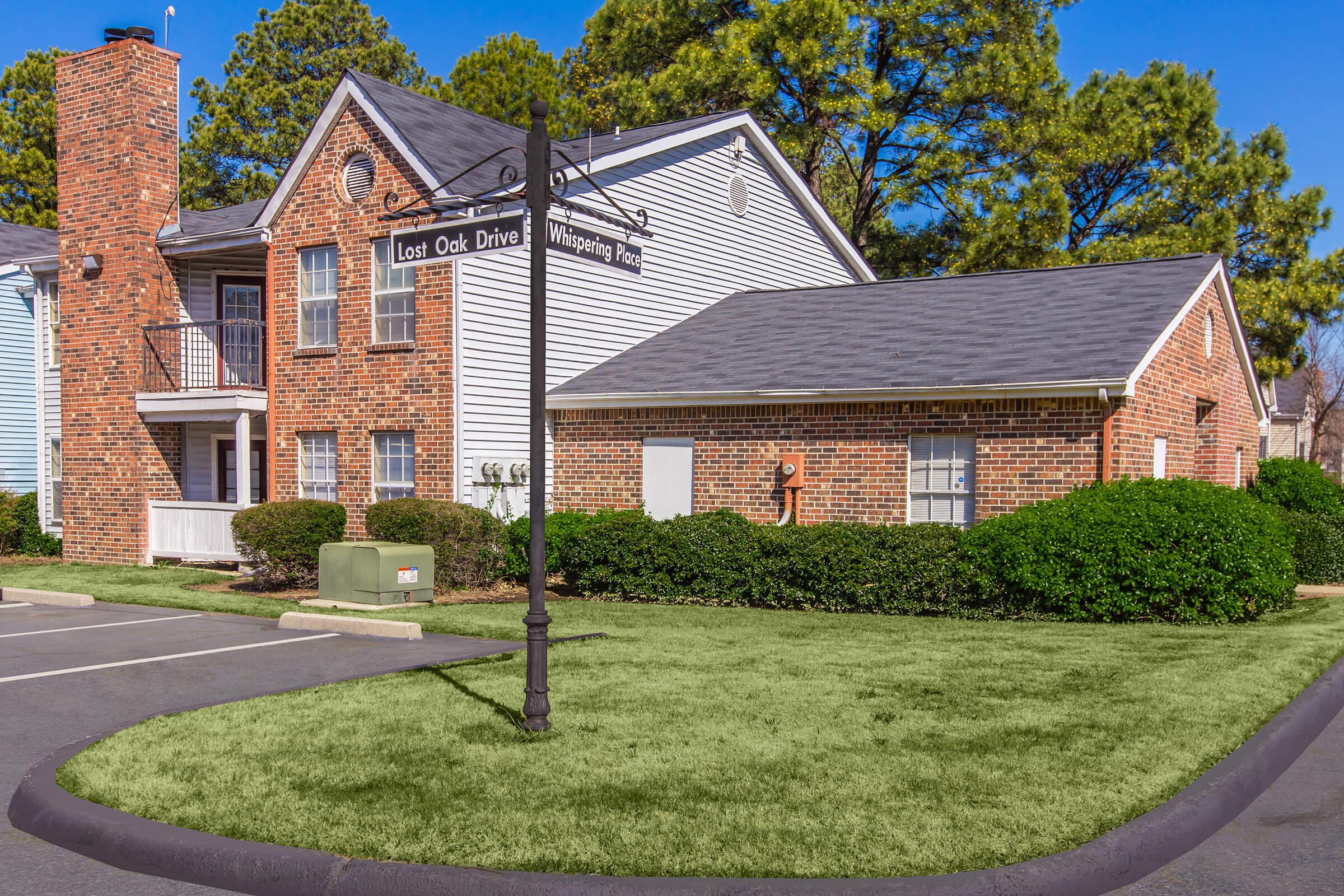 Well-maintained apartments with trees and flowering bushes.