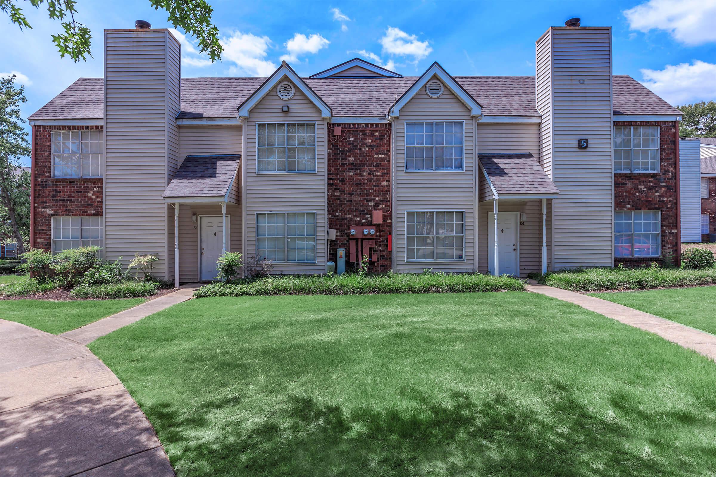 Apartments with balconies and landscaped pathways.