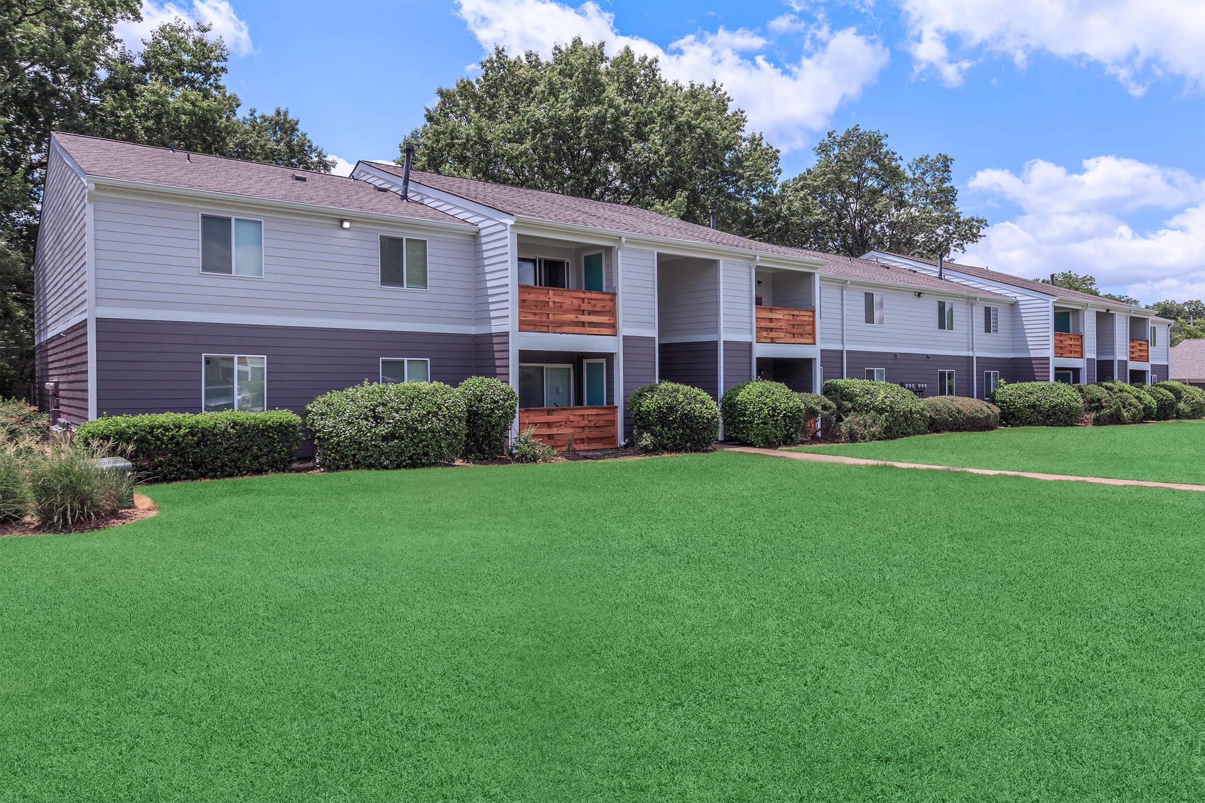 Apartment buildings with well-maintained landscaping.