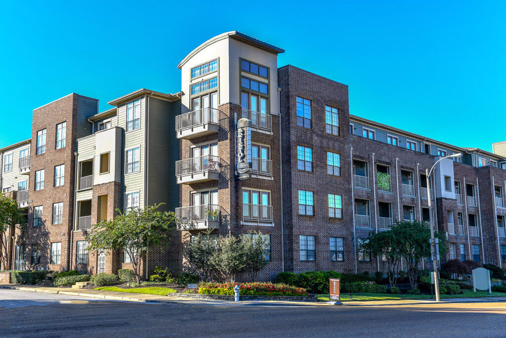 Exterior of a modern apartment complex with landscaping.