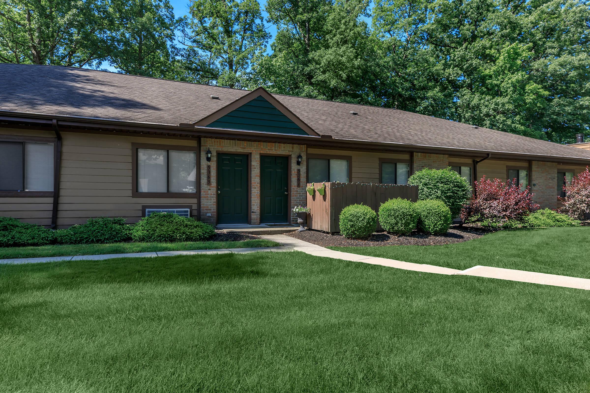 Building exterior with 2 front doors and windows.