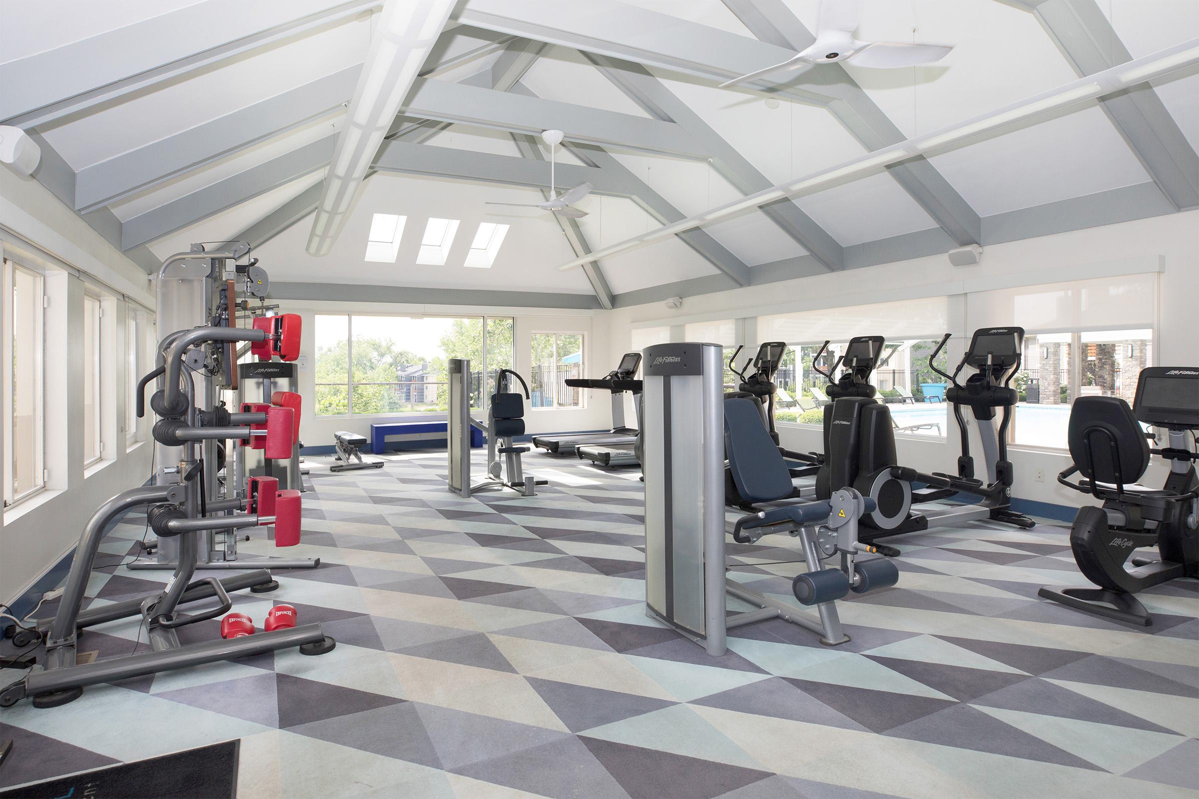 Interior gym space with various fitness equipment.