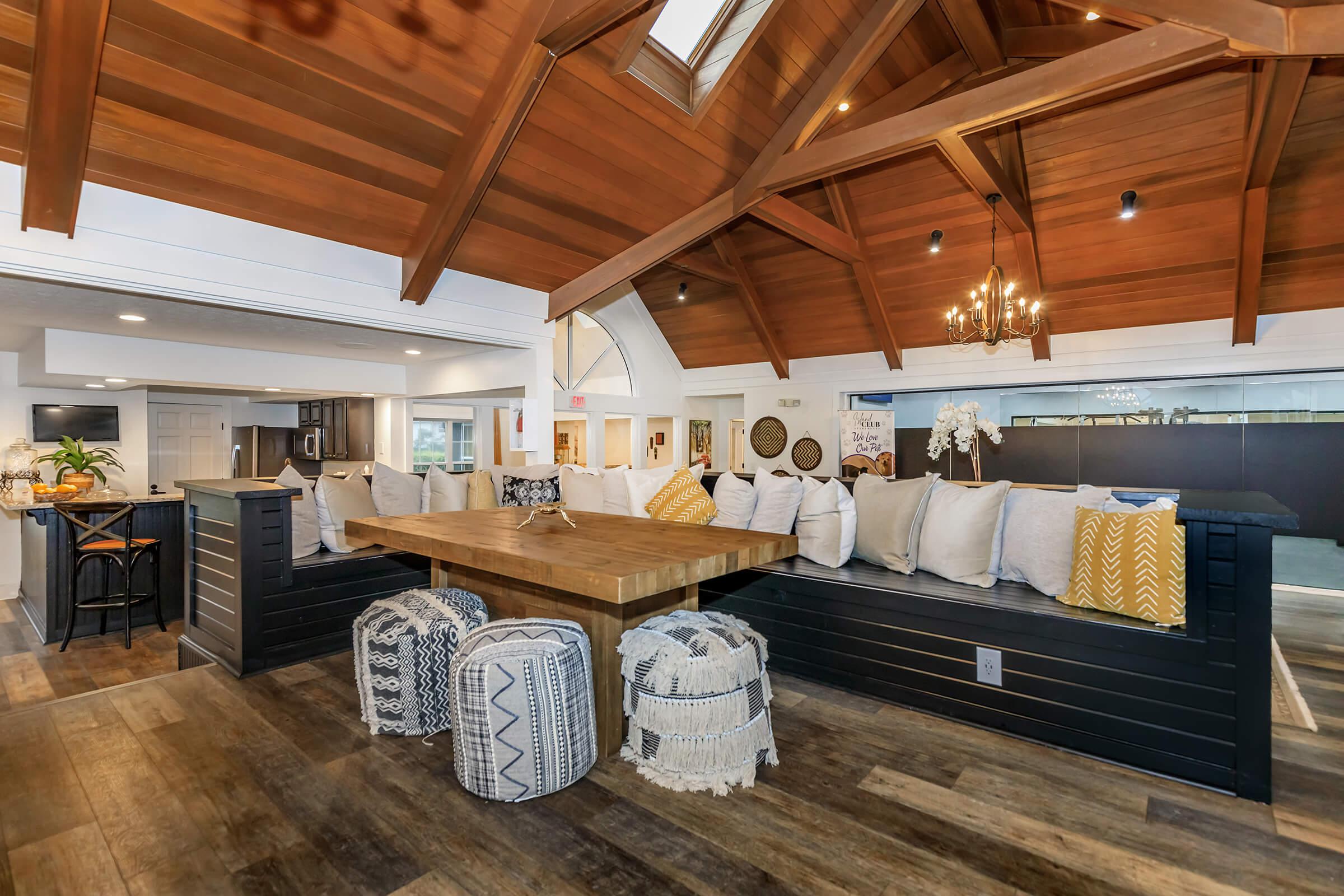 living area with dropped wood ceiling