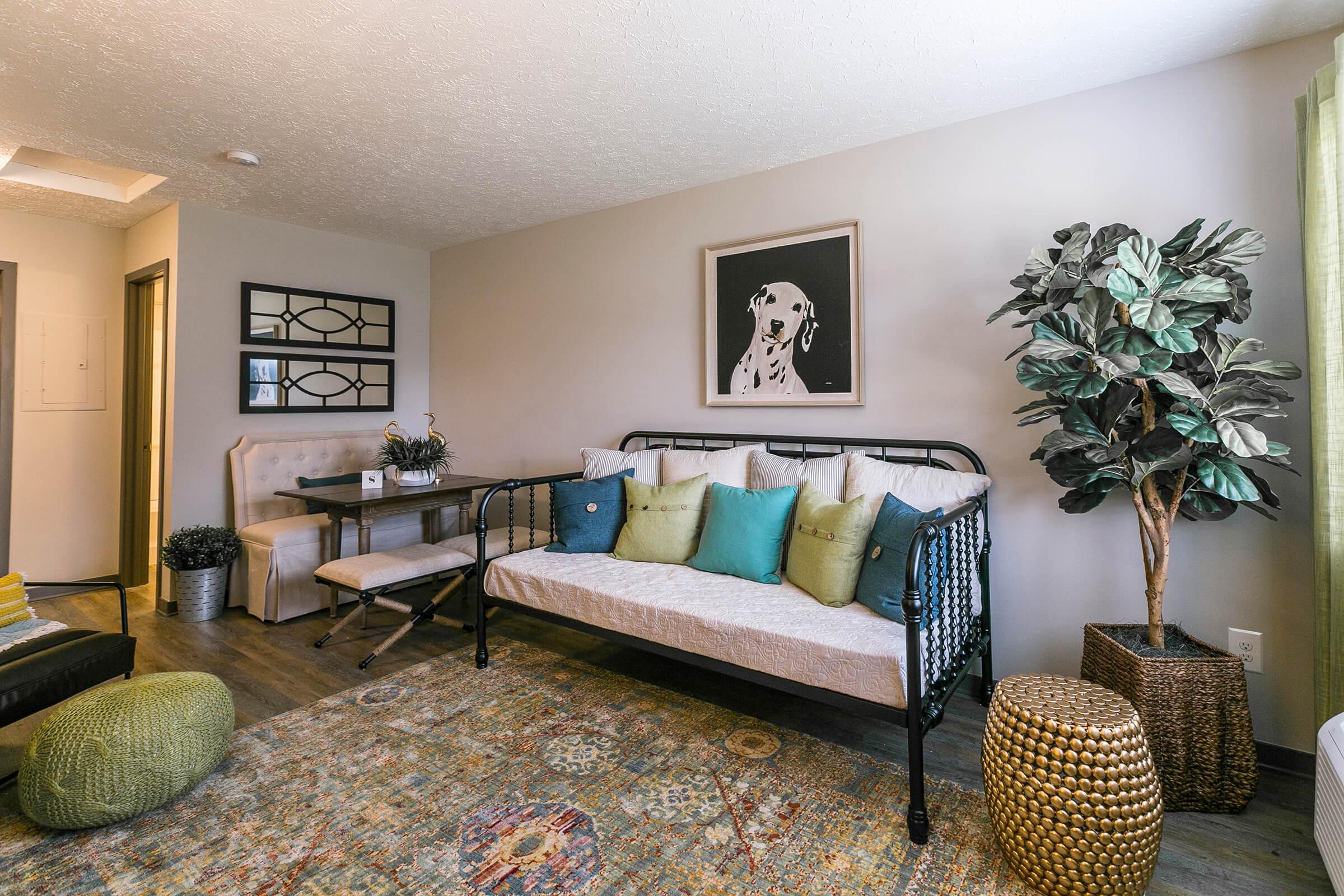 Living room with stylish decor, couch, and wall art.