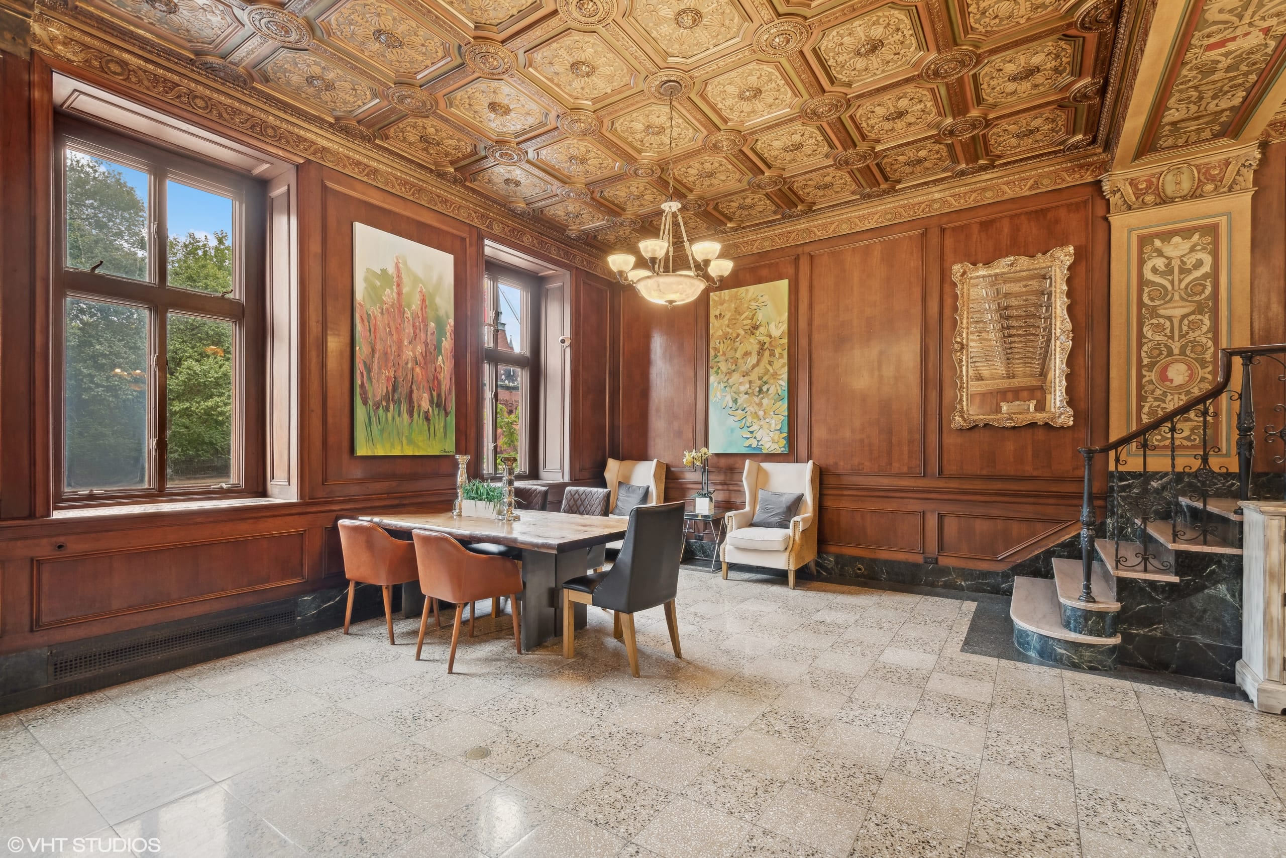 Elegant dining area with ornate wood-paneled walls and decorative ceiling.