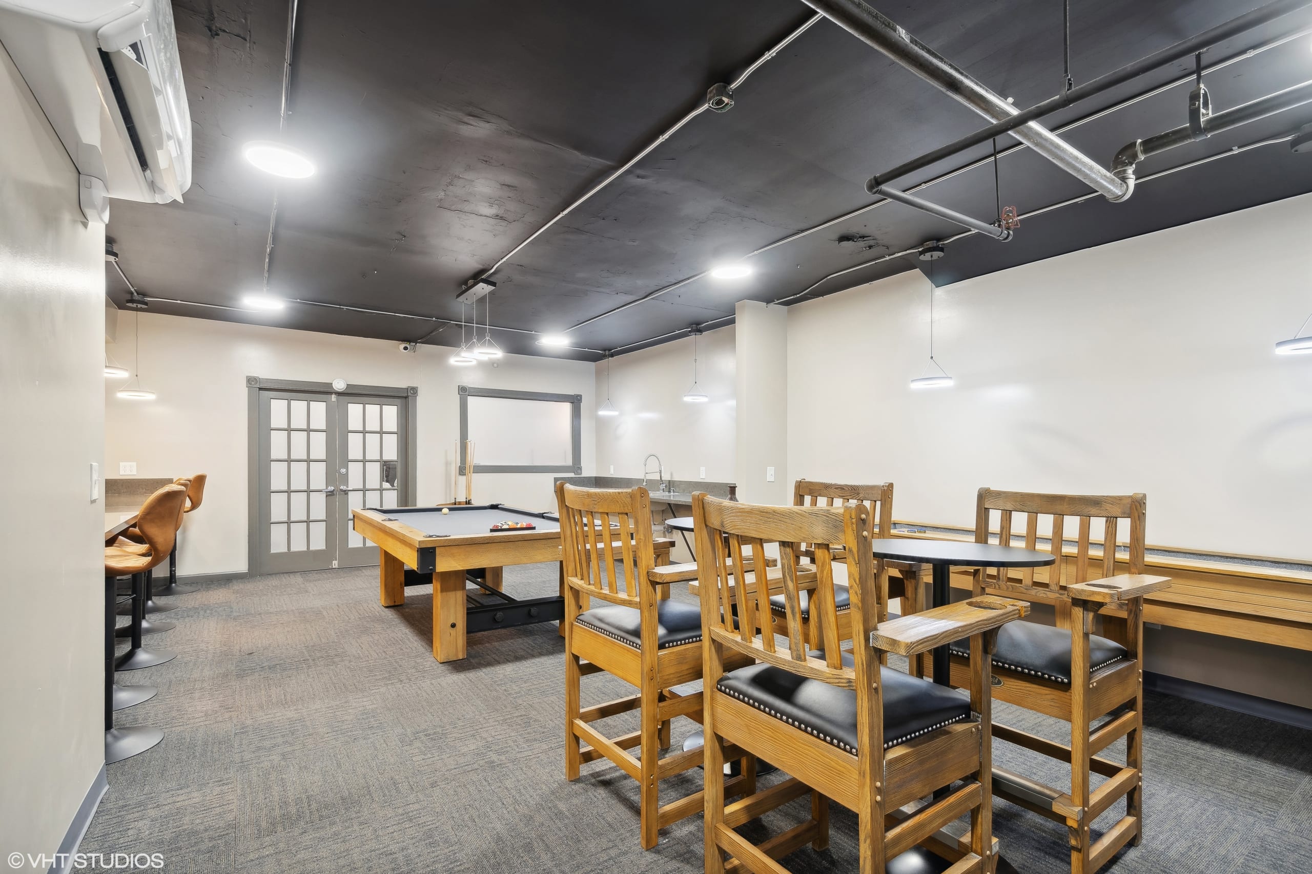 Dining and meeting area with long wooden tables and chairs.